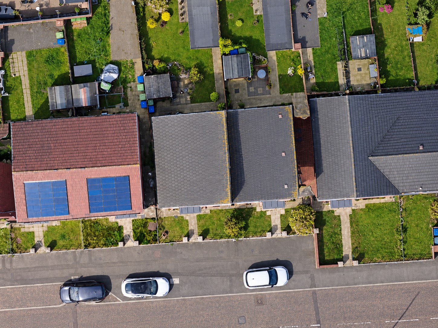 Cropped Sunderland orthophoto showing residential rooftops, gardens and the adjacent road from above.